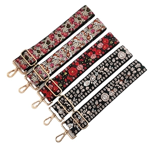 Five assorted colorful embroidered shoulder straps with bohemian floral patterns and gold clips