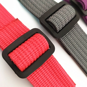 Detail of adjustable nylon backpack chest straps in rose red and grey with plastic buckles
