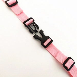 Pink adjustable nylon backpack chest strap with black plastic buckles and durable webbing