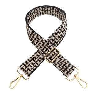 Adjustable black and beige houndstooth nylon bag strap with gold metal swivel hooks