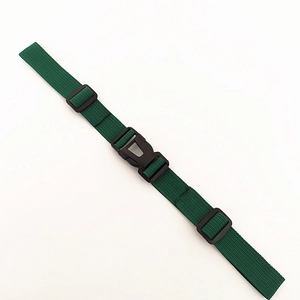 Detail view of dark green adjustable nylon backpack chest strap with black plastic buckle