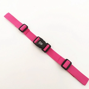 Detail of rose red nylon chest strap with black plastic buckles for backpacks