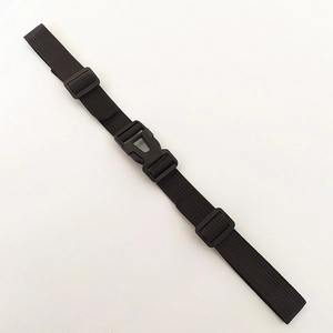 Close-up of durable black nylon backpack chest strap with adjustable plastic buckle and rings