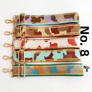 Detail view of five adjustable jacquard camo bag straps with golden swivel lobster clasps