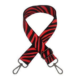 Adjustable nylon shoulder strap with red and black zebra pattern and gunmetal hooks