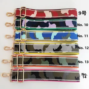 Detail of adjustable wide camouflage straps with gold metal hooks and colorful patterns