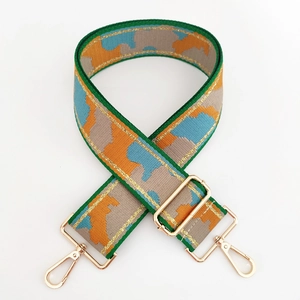 Detailed view of colorful adjustable woven bag strap with golden metal spring hooks
