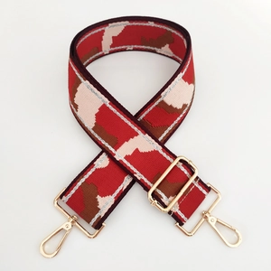 Close-up of pink camo wide bag strap with silver metallic thread and gold buckles