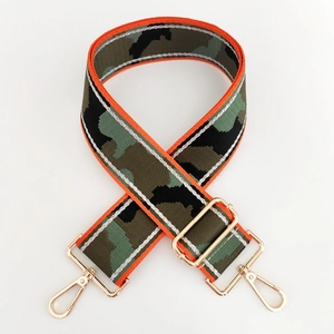 Close-up of adjustable wide camouflage strap with orange edges and gold metal hooks