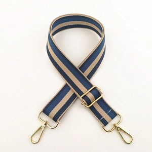Close-up of adjustable blue and beige striped woven strap with gold metal lobster clasps