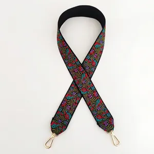 Detailed view of vintage floral embroidery strap with golden metal swivel hooks