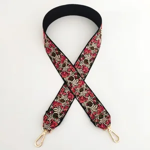 Detail of floral embroidery on bag strap with high-quality golden metal hooks