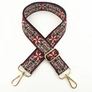 Detail of wine red bohemian embroidered strap with floral jacquard and gold metal hooks
