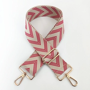 Detail of red and beige chevron weave strap with adjustable gold-tone metal hardware