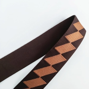 Detail of coffee brown woven strap with light brown diamond pattern and thick texture