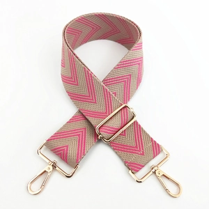 Adjustable wide woven shoulder strap with pink chevron pattern and gold metal hooks