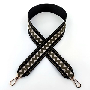 Detail of bohemian geometric woven wide bag strap with durable gold swivel metal hooks