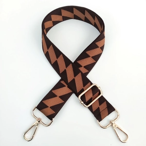 Adjustable zigzag pattern shoulder strap with gold-tone hardware for crossbody bags