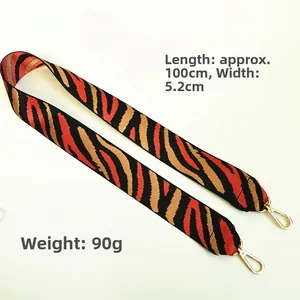 Detailed view of striped nylon bag strap with 5.2cm width and golden metal lobster clips