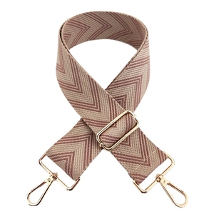 Adjustable woven chevron shoulder strap with beige and maroon patterns and gold buckles