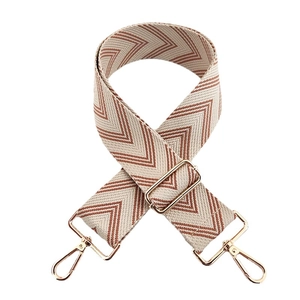 Adjustable woven wide bag strap with cream and brown geometric patterns and gold clips