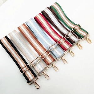Adjustable nylon shoulder straps with metallic stripes and gold metal buckles for handbags