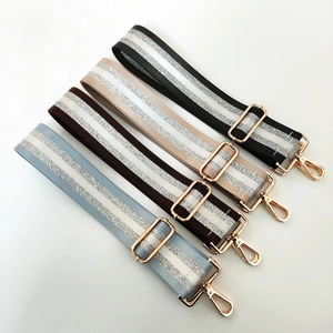 Detail view of adjustable nylon bag straps in four colors with shimmering silver glitter stripes