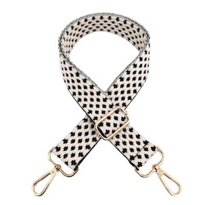 Adjustable black and white geometric pattern woven shoulder strap with gold metal buckles