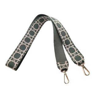 Adjustable woven shoulder strap for handbags with dark green geometric patterns and gold clips