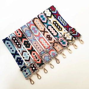 Detail of colorful geometric woven canvas bag straps with gold metal lobster clasps