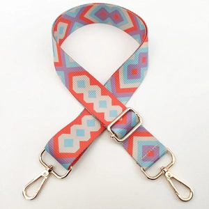 Macro detail of geometric ethnic style canvas strap with gold metal lobster clasps