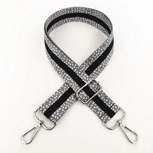 Macro shot of 3.8cm wide woven bag strap with white dots and silver metal lobster clasps