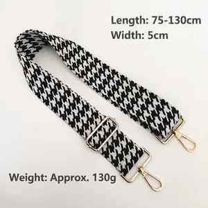 Adjustable black and white houndstooth jacquard shoulder strap with gold metal hardware