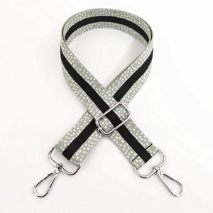 Detail of adjustable 3.8cm wide bag strap with grey spotted texture and silver metal clips