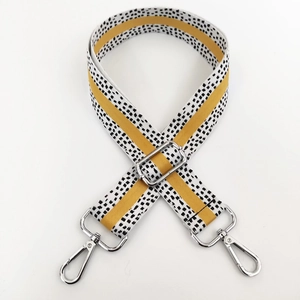 Detail of 3.8cm wide bag strap with black white checker pattern and yellow stripe center