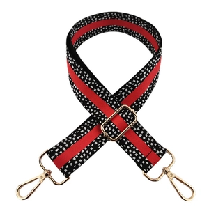Adjustable 3.8cm wide bag strap with red, black and white patterns and gold hardware
