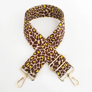 Detail of adjustable leopard print bag strap with golden metal swivel hooks and buckles