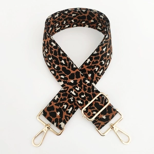 Close-up of leopard print jacquard bag strap with adjustable gold hardware and metal hooks