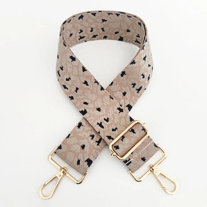Close-up of leopard jacquard wide strap with gold metal hooks and adjustable buckle