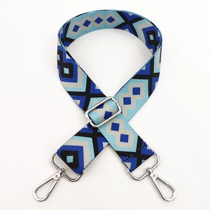 Detail of colorful geometric diamond pattern shoulder strap with silver metal swivel hooks
