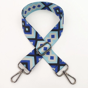 Detail of adjustable geometric ethnic style fabric strap with dark metal swivel hooks