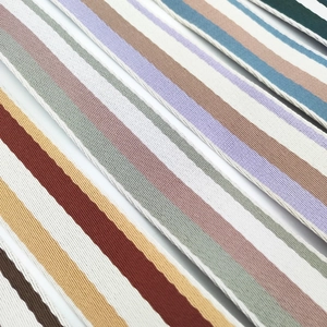 Close-up of high-density striped canvas bag straps in various colors with twill weave
