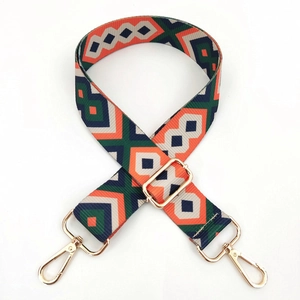 Detail of adjustable geometric woven shoulder strap with gold metal swivel hooks