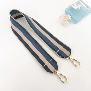 Close-up of tricolor striped bag strap with durable fabric and gold lobster clasps