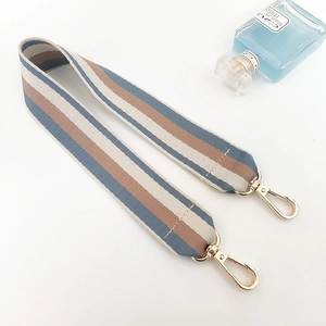 Detailed view of vintage striped fabric strap with premium polished gold metal clasps