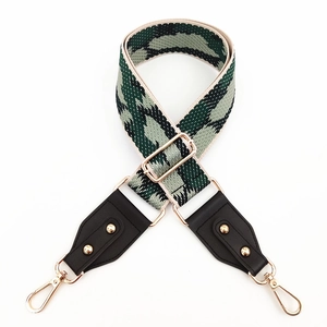 Détail de la bandoulière ajustable en jacquard camouflage avec crochets dorés et embouts cuir
