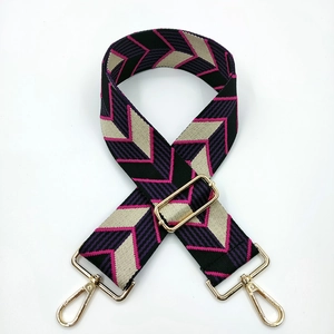 Detail of wide adjustable shoulder strap with purple and black geometric chevron pattern