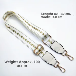 Detailed view of adjustable white nylon strap with gold V-pattern and faux leather ends