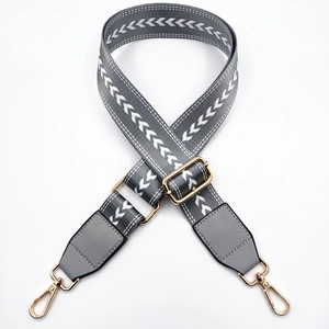 Adjustable grey nylon bag strap with white arrow embroidery and golden hooks