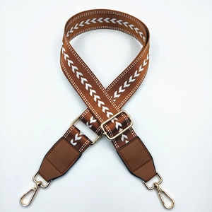 Adjustable brown nylon shoulder strap with white arrow pattern and gold metal hooks